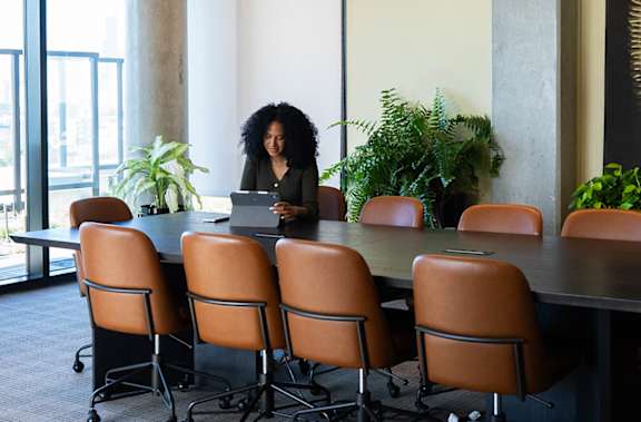 Woman sitting in conference room at Scout Living, powered by Placemakr, Atlanta, Georgia