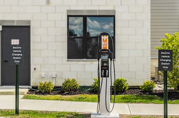 An electric vehicle charging station sits outside a building at Upper Vue Flats, Dublin, OH, 43016
