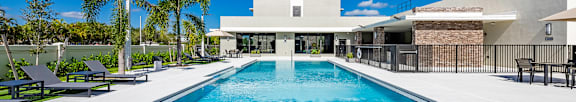A large outdoor swimming pool surrounded by a fence.