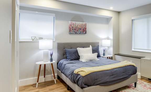 large bedroom with large windows and custom closets