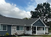 Thumbnail 9 of 36 - a parking lot in front of a house with a driveway
