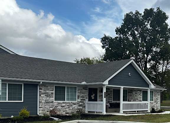 a parking lot in front of a house with a driveway