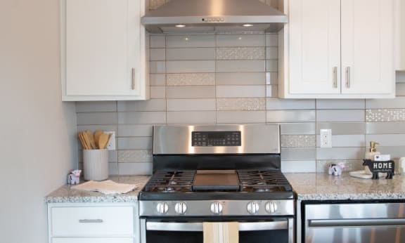 a kitchen with stainless steel appliances and white cabinets