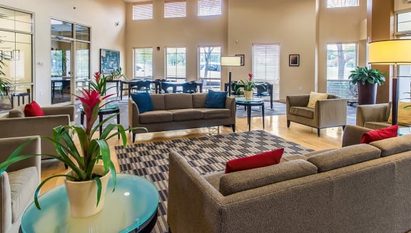 a lobby with couches and chairs and a table