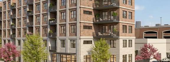 A modern apartment building with balconies and multiple stories.
