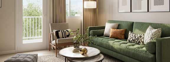 Living room with a green couch, coffee table and balcony