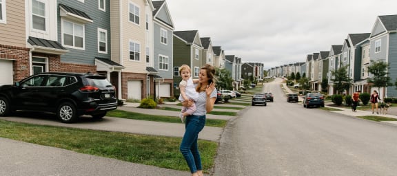 a documentary photograph of a mother and daughter standing in the middle of the road in front of