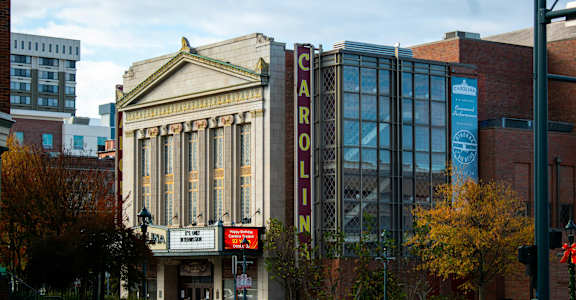 a large building with a sign that reads auditorium on a city street