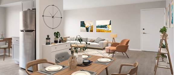 a living room and dining room with a table and chairs and a large clock on the wall at Bedford Castle, Bedford Heights, OH