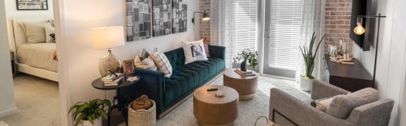 a living room with a blue couch and a window