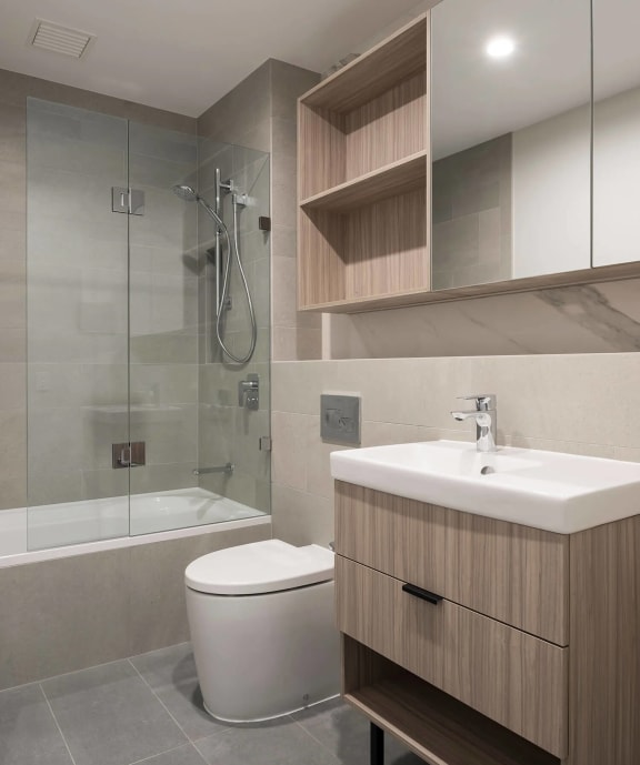 a bathroom with a toilet and a sink and a shower