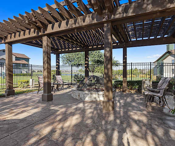 a patio with a wooden pergola and a fire pit at The Fairways at Star Ranch, Hutto