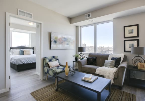 living room of an apartment with a couch, coffee table, an decor