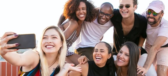 Group of friends hanging out together and taking a selfie