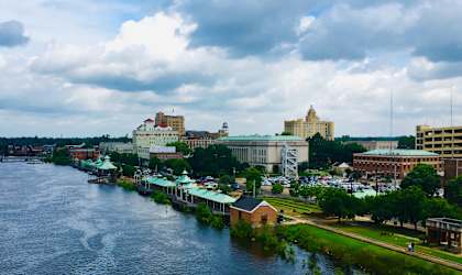 A river flows through a city with buildings on both sides.