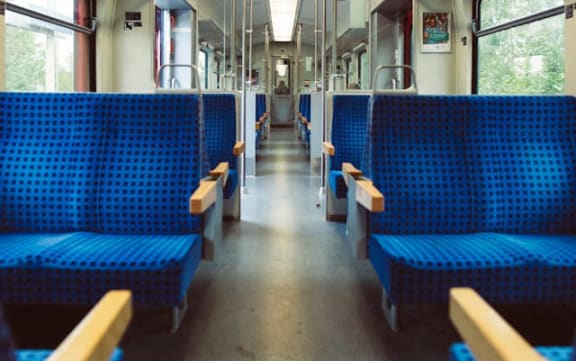 the inside of a train with blue benches