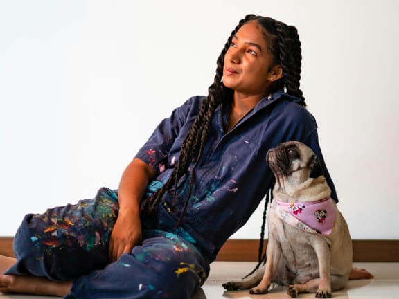 a woman sitting on the floor with her dog