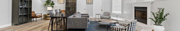 A living room with a fireplace and a couch. at Eagles Edge Apartments, Indiana