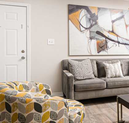 a living room with a ceiling fan and couch