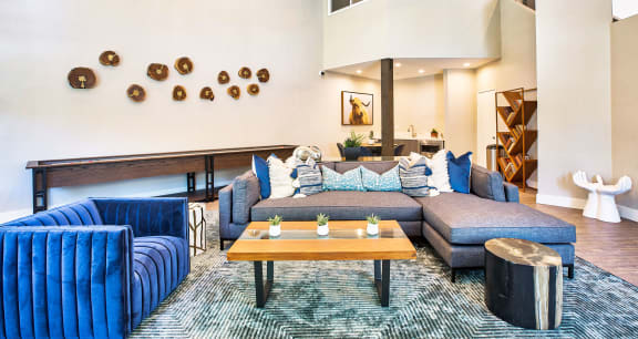 a living room with blue couches and a coffee table