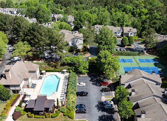 A bird's eye view of Wesley Place apartments, a swimming pool, and a tennis court.