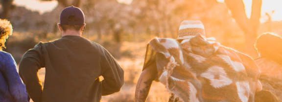 a group of people running in the desert