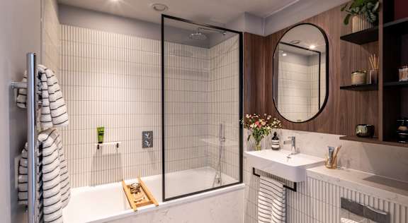 A modern bathroom with a walk-in shower and a toilet.