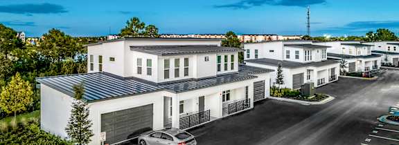 a rendering of a large apartment building with people riding bikes at The Overlook in Winter Garden, FL