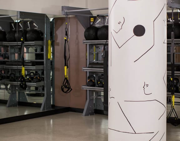 a large white column with a face on it in a garage at The Flat, California