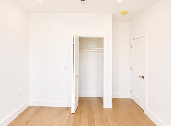 A room with a white door and a white wall.
