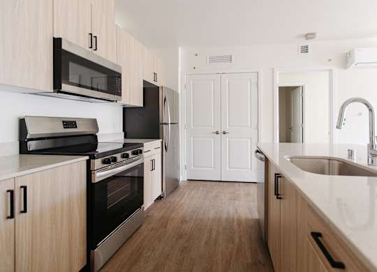 Open concept kitchen with island at The Elowen apartments in Lacey