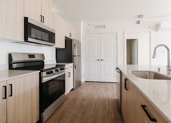 Open concept kitchen with island at The Elowen apartments in Lacey