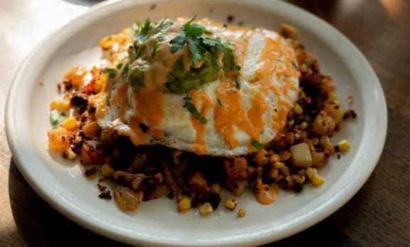 a plate of food with an egg and rice on it