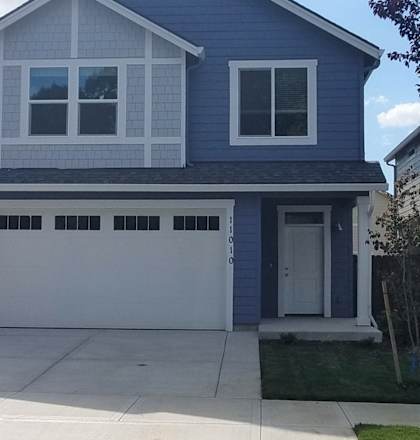 A blue house with a white garage door.