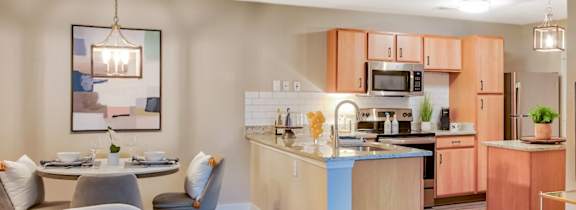 A modern kitchen with a dining table and chairs.