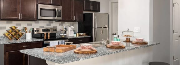 a kitchen with granite counter tops and stainless steel appliances