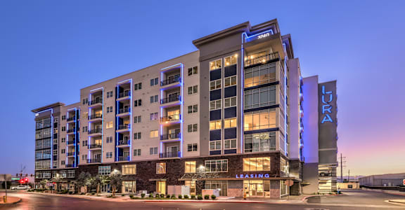 A modern apartment building with a leasing office in front.
