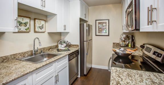 a kitchen with granite counter tops and stainless steel appliances at Valley Plaza Villages, Pleasanton, California