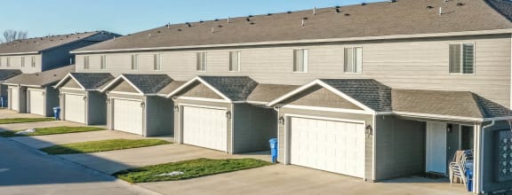 a row of houses with garages