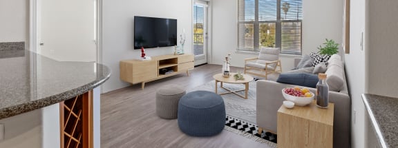 a living room with white walls and hardwood flooring