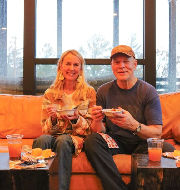 a man and a woman sitting on a couch eating at Bluestone Flats, Duluth, MN
