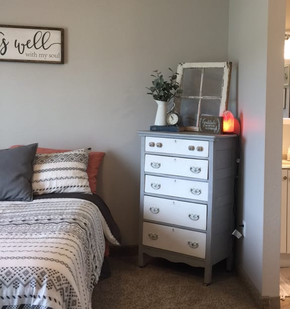a bedroom with a bed and a ceiling fan