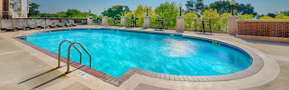 A rectangular pool with a metal railing around it.