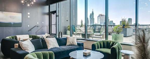 A modern living room with a view of the city skyline.