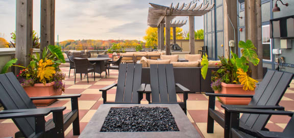 a patio with tables and chairs on a roof
