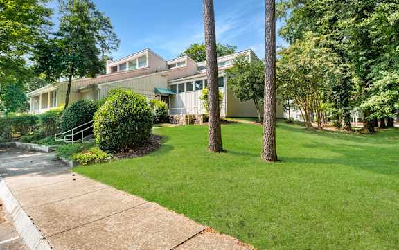 A house with a green lawn and trees in front. at Blue Ridge Estates, Virginia, 23225