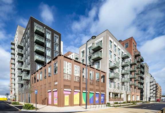 A row of modern buildings with a blue sky in the background.