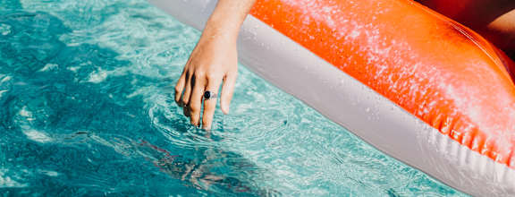Hands in Pool at The Herald Apartments