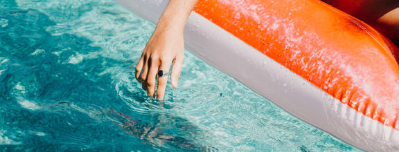 Hands in Pool at The Herald Apartments