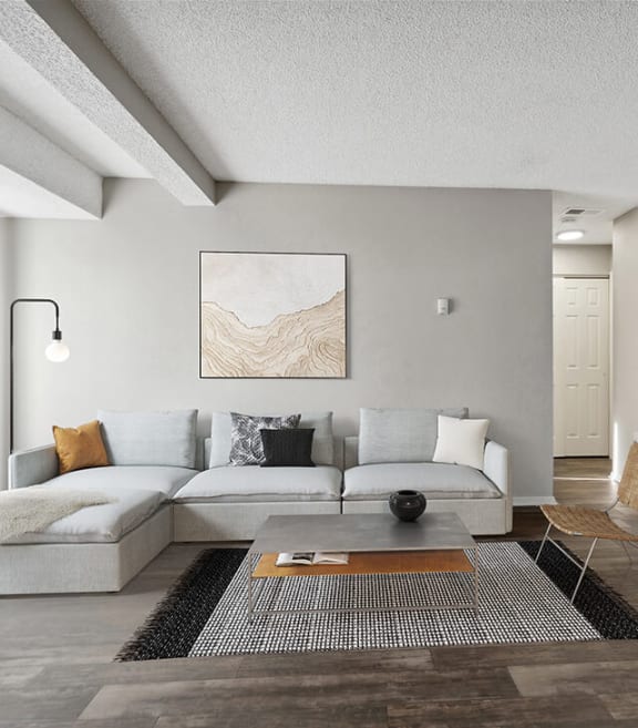 Model Living Room with Wood-Style Flooring and Patio Accessibility at Liberty Creek Apartments in Aurora, CO-SMLAM.